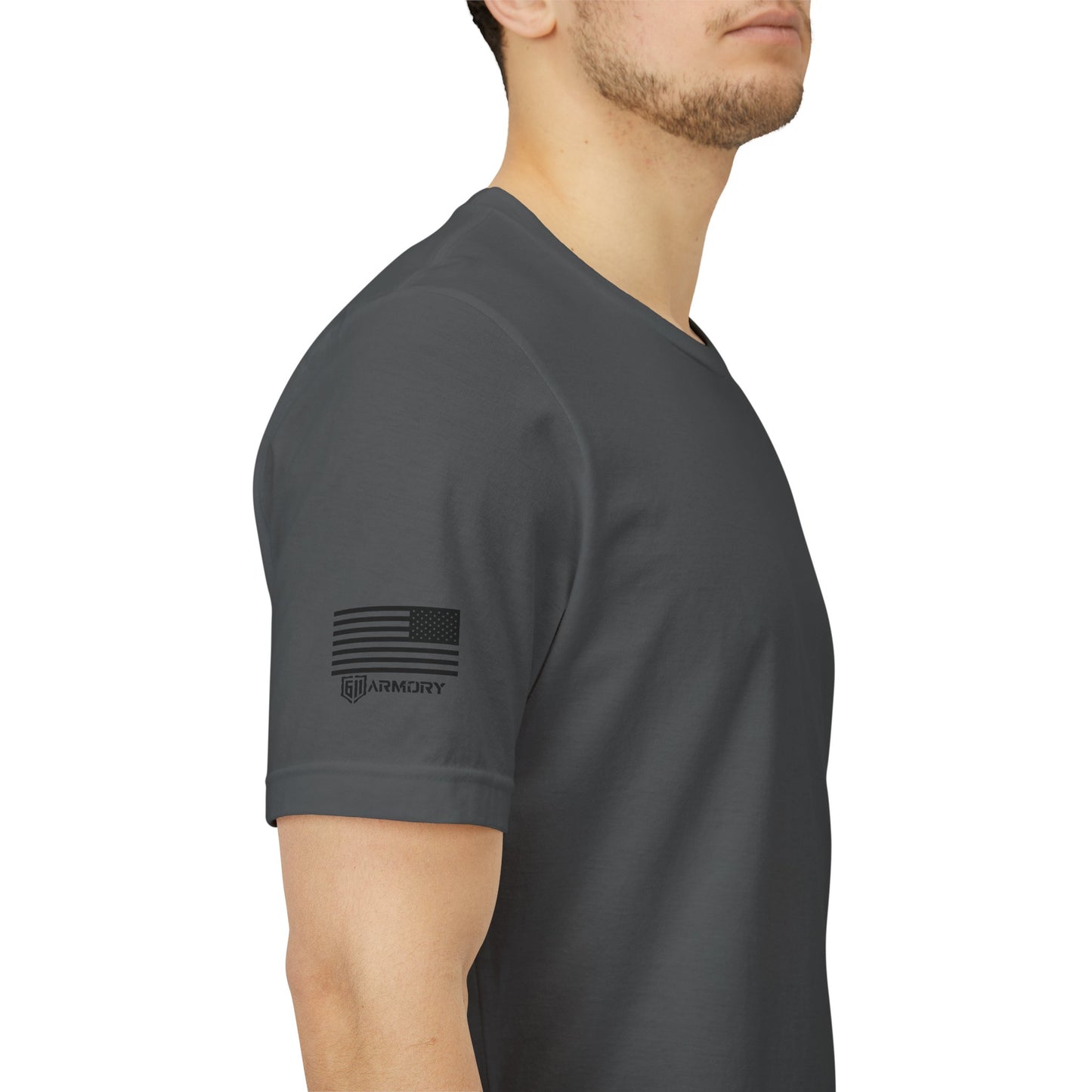 Person wearing a dark gray t-shirt with a logo on the sleeve against a white background