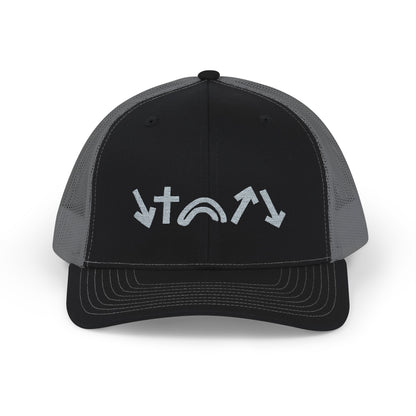 A black and charcoal trucker cap is displayed, featuring five symbolic designs in white on the front. The symbols include a cross and various arrow shapes, showcasing a modern and meaningful aesthetic.