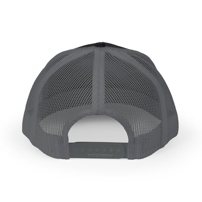 The image shows the back view of a trucker cap featuring a gray mesh design. The cap has a black fabric front and an adjustable strap with the brand name RICHARDSON visible on the back.