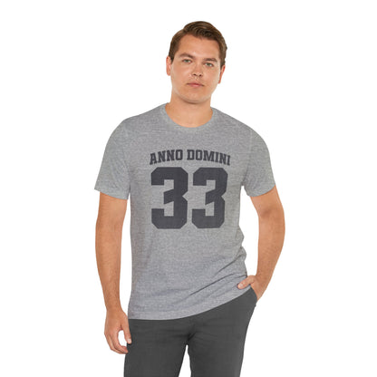 Man wearing a gray t-shirt with 'ANNO DOMINI 33' text on a white background