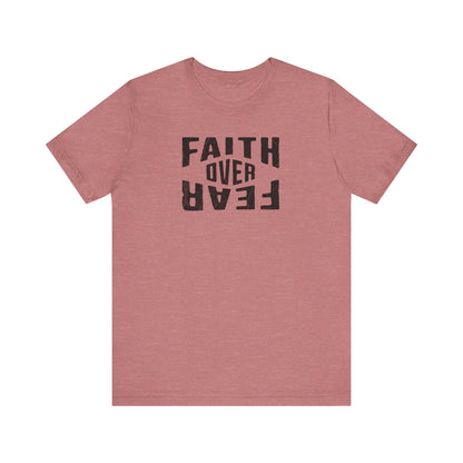 Pink t-shirt with 'Faith Over Fear' text on a white background