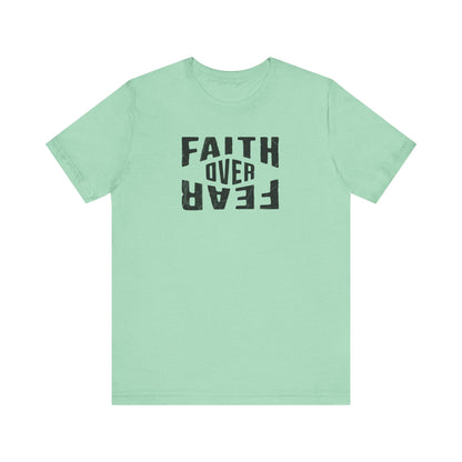 Light green t-shirt with 'Faith Over Fear' text on a white background
