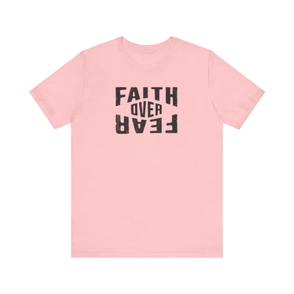 Pink t-shirt with 'Faith Over Fear' text on a white background