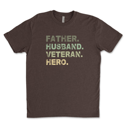 A brown t-shirt with the text 'Father, Husband, Veteran, HERO' printed in a camouflage pattern.