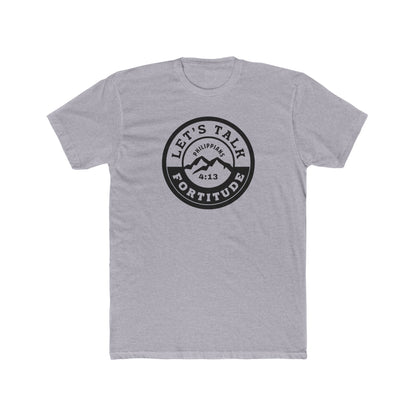 A beige t-shirt with a circular black logo print containing text and a mountain and sunset graphic in the center.