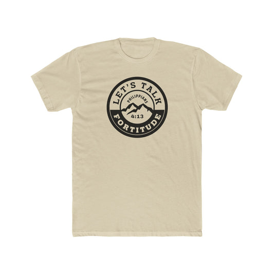 A beige t-shirt with a circular black logo print containing text and a mountain and sunset graphic in the center.