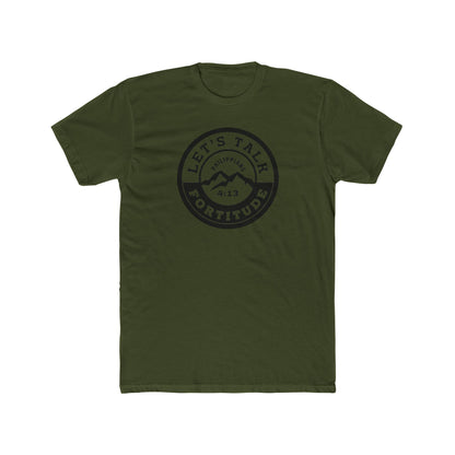 A beige t-shirt with a circular black logo print containing text and a mountain and sunset graphic in the center.