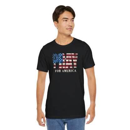 Man wearing a black t-shirt with an American flag design and text on a white background
