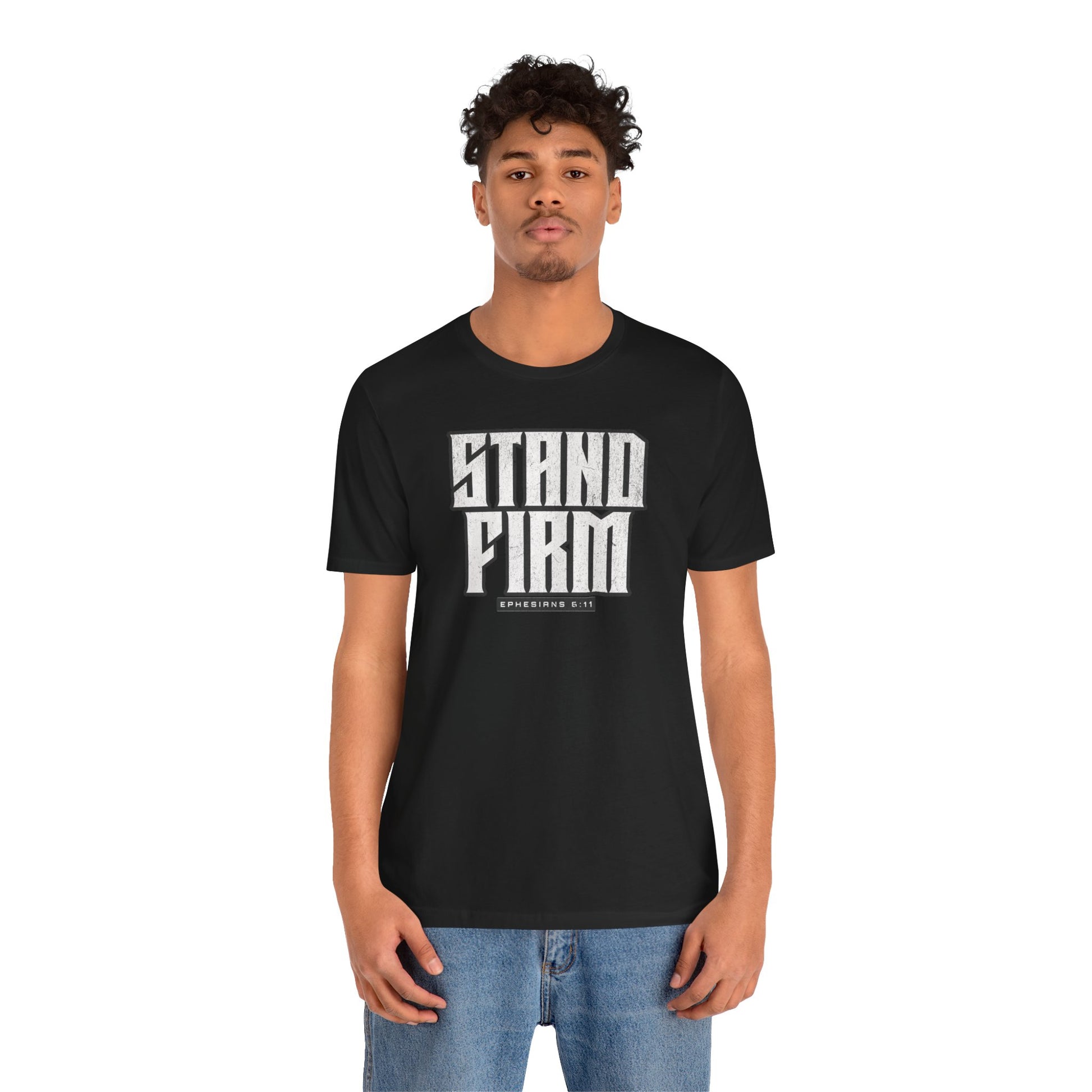Person wearing a black t-shirt with 'STAND FIRM' text on a white background