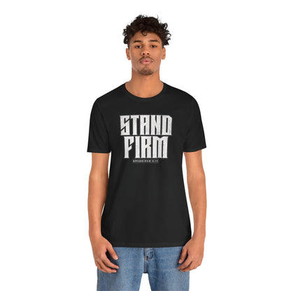 Person wearing a black t-shirt with 'STAND FIRM' text on a white background