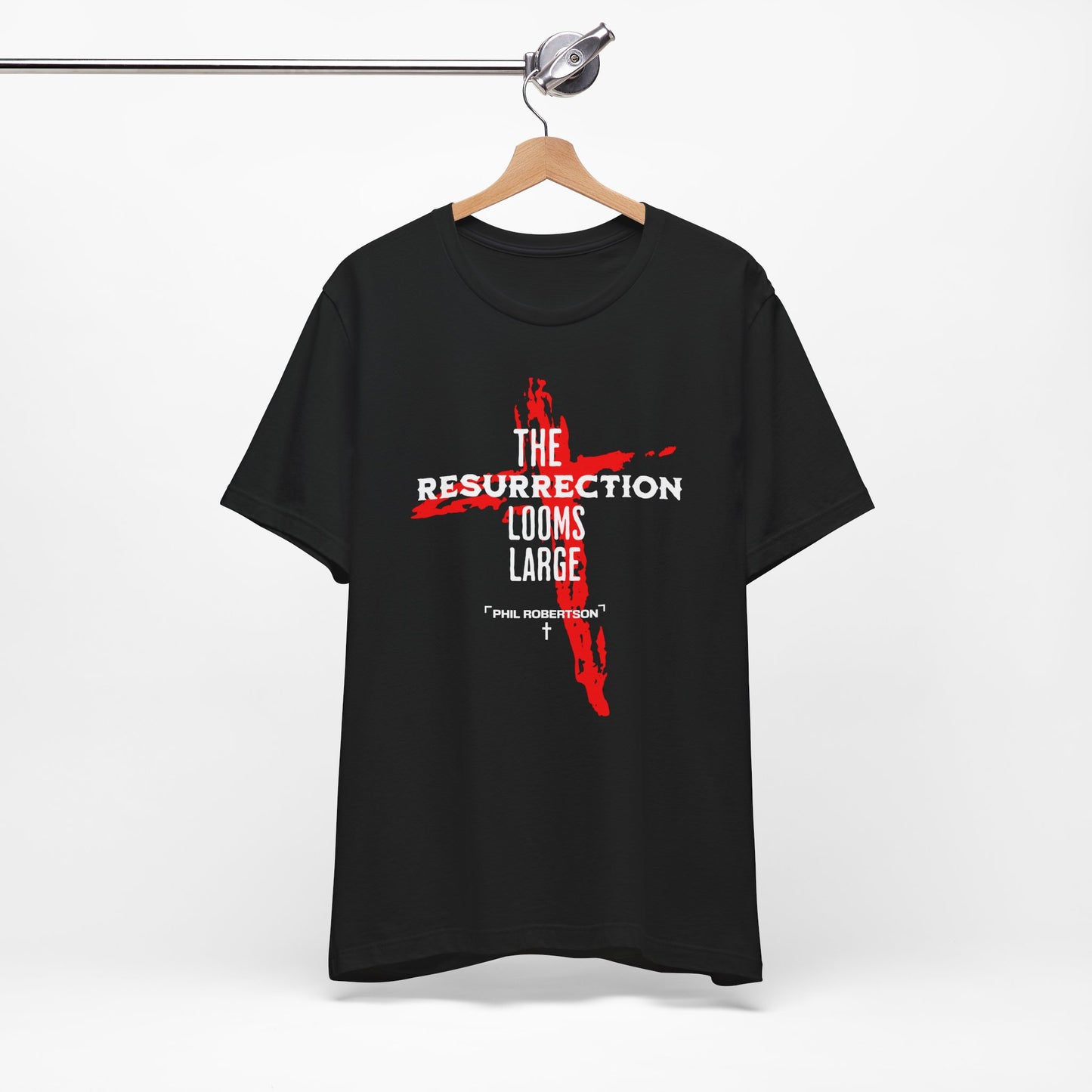 Black t-shirt with red and white graphic design on a hanger against a white background