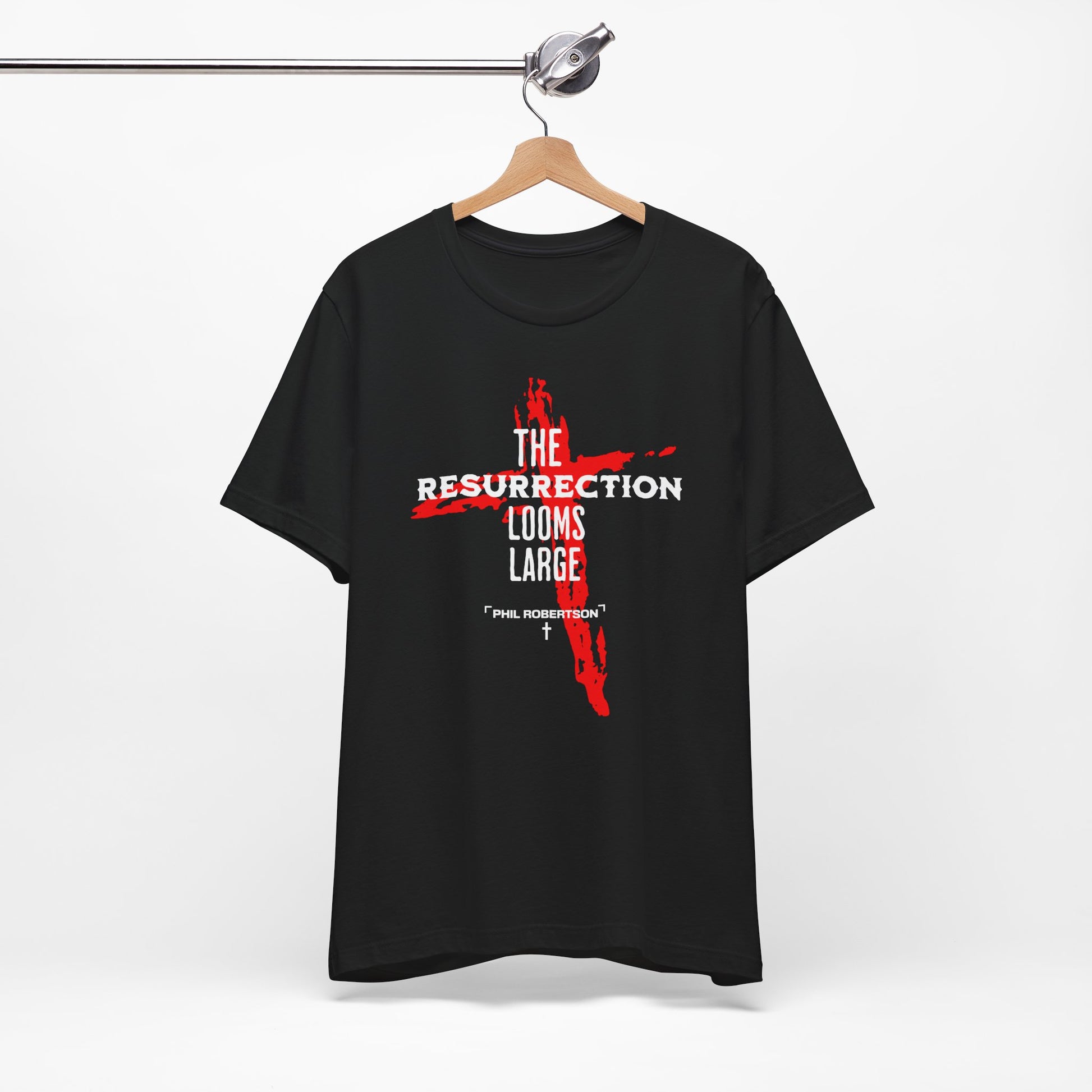 Black t-shirt with red and white graphic design on a hanger against a white background