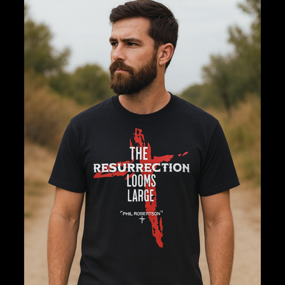 Man wearing a black t-shirt with a resurrection graphic and text outdoors